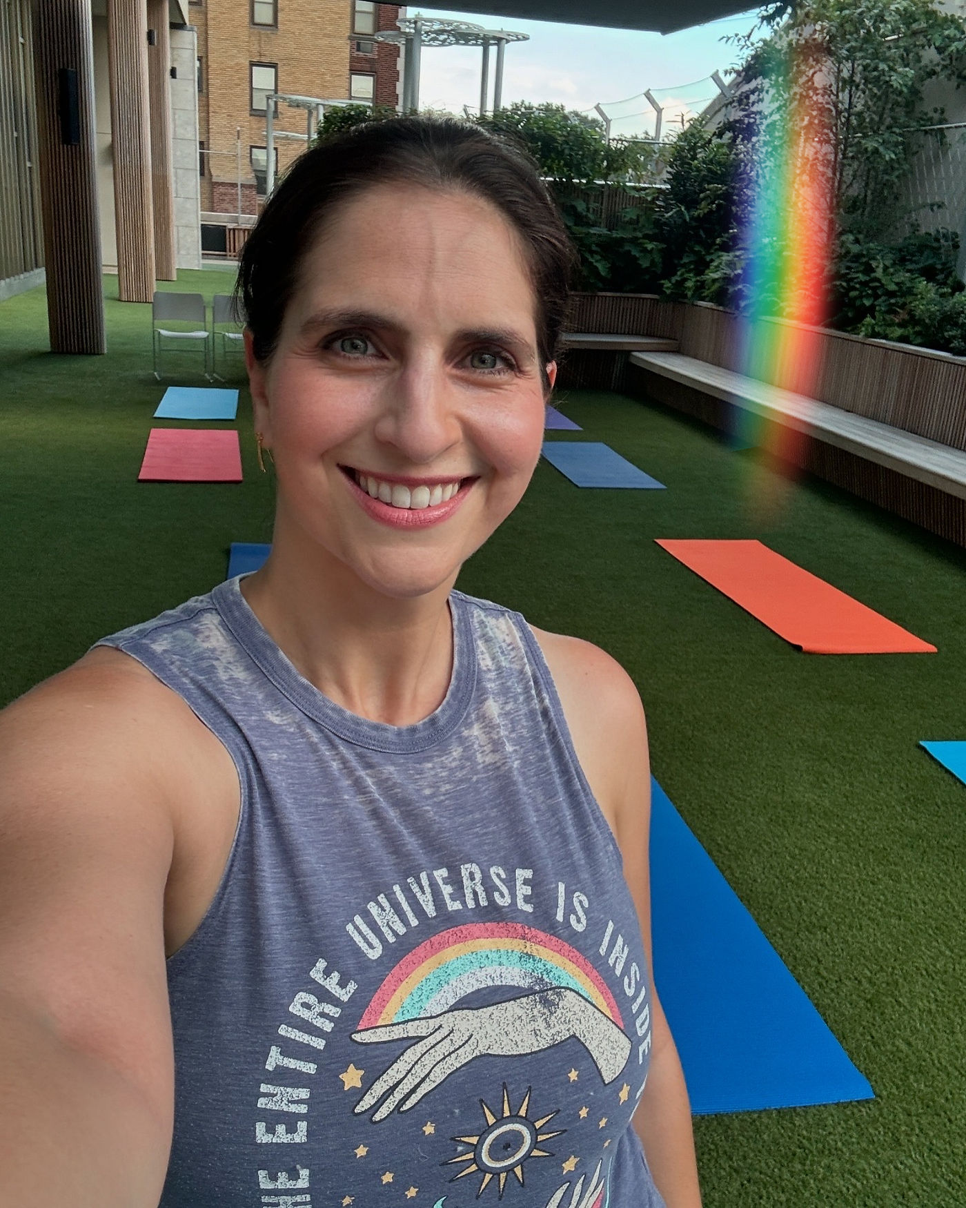 Lola Maltz Cohen smiling on a rooftop yoga deck