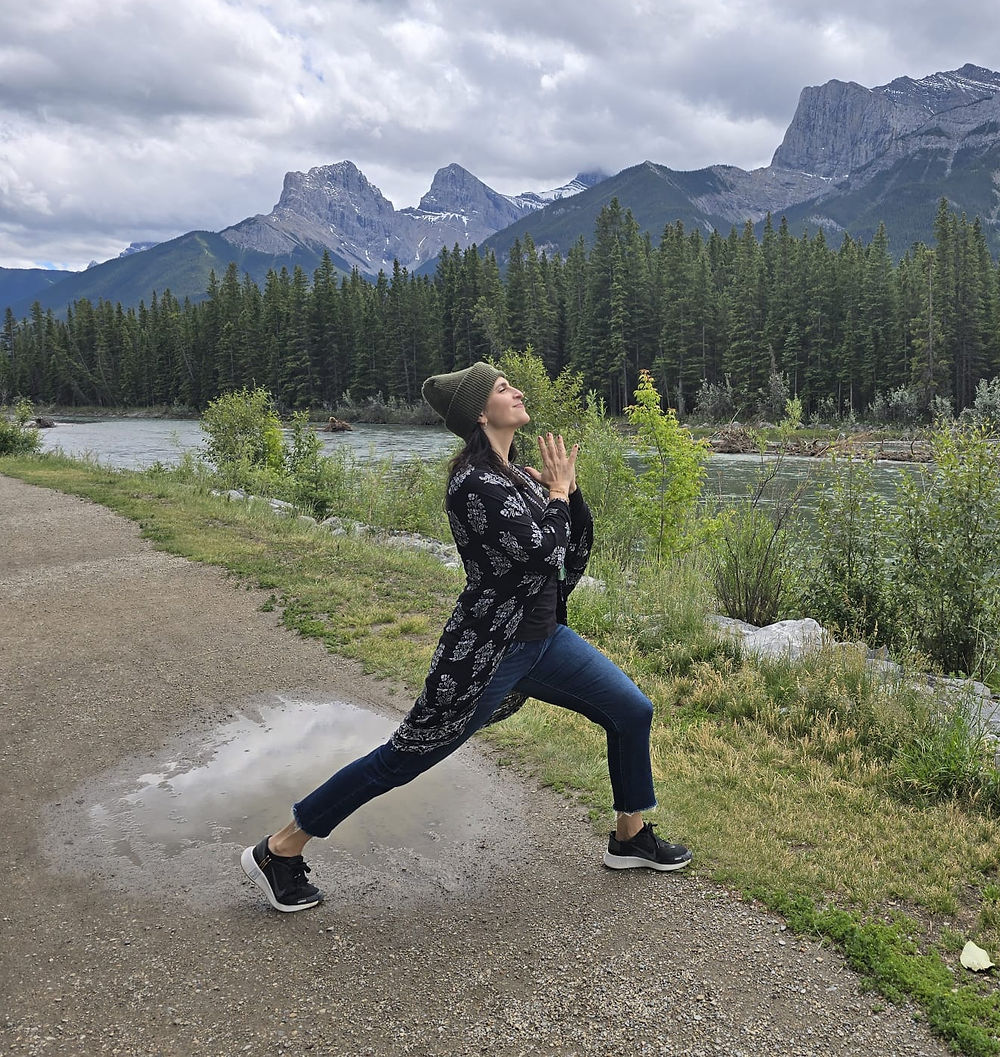 Lola Maltz Cohen in a yoga warrior pose outdoors in the mountains